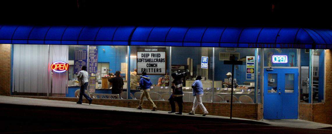 Customers make their way by the Palmetto Seafood Company on Gervais Street after buying a box of oysters. The store which first opened in 1961 is now owned by Lucius Moultrie who bought the business in 1997.