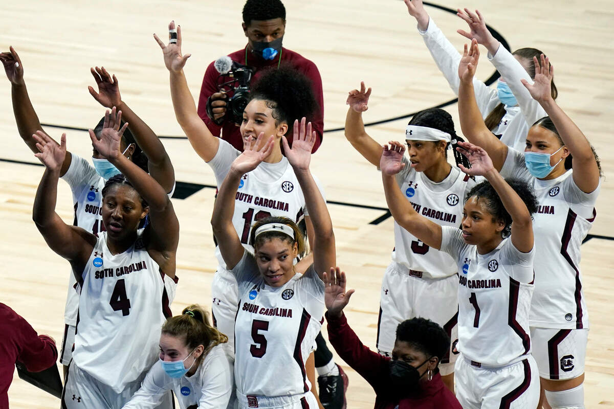 South Carolina players wave to fans as they celebrate their win over Georgia Tech in a college basketball game in the Sweet Sixteen round of the women’s NCAA tournament at the Alamodome in San Antonio, Sunday, March 28, 2021.