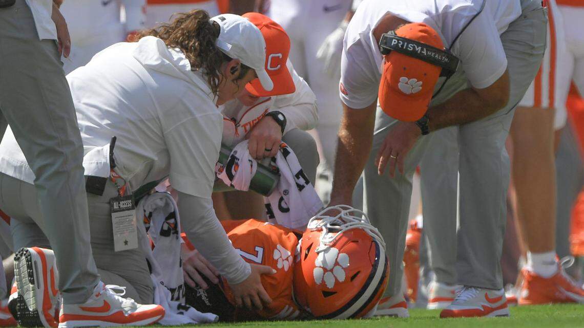Sep 21, 2024; Clemson, South Carolina, USA; Clemson Tigers running back Phil Mafah (7) is examined by trainers and head coach Dabo Swinney after suffering an apparent injury against the North Carolina State Wolfpack during the first quarter at Memorial Stadium.