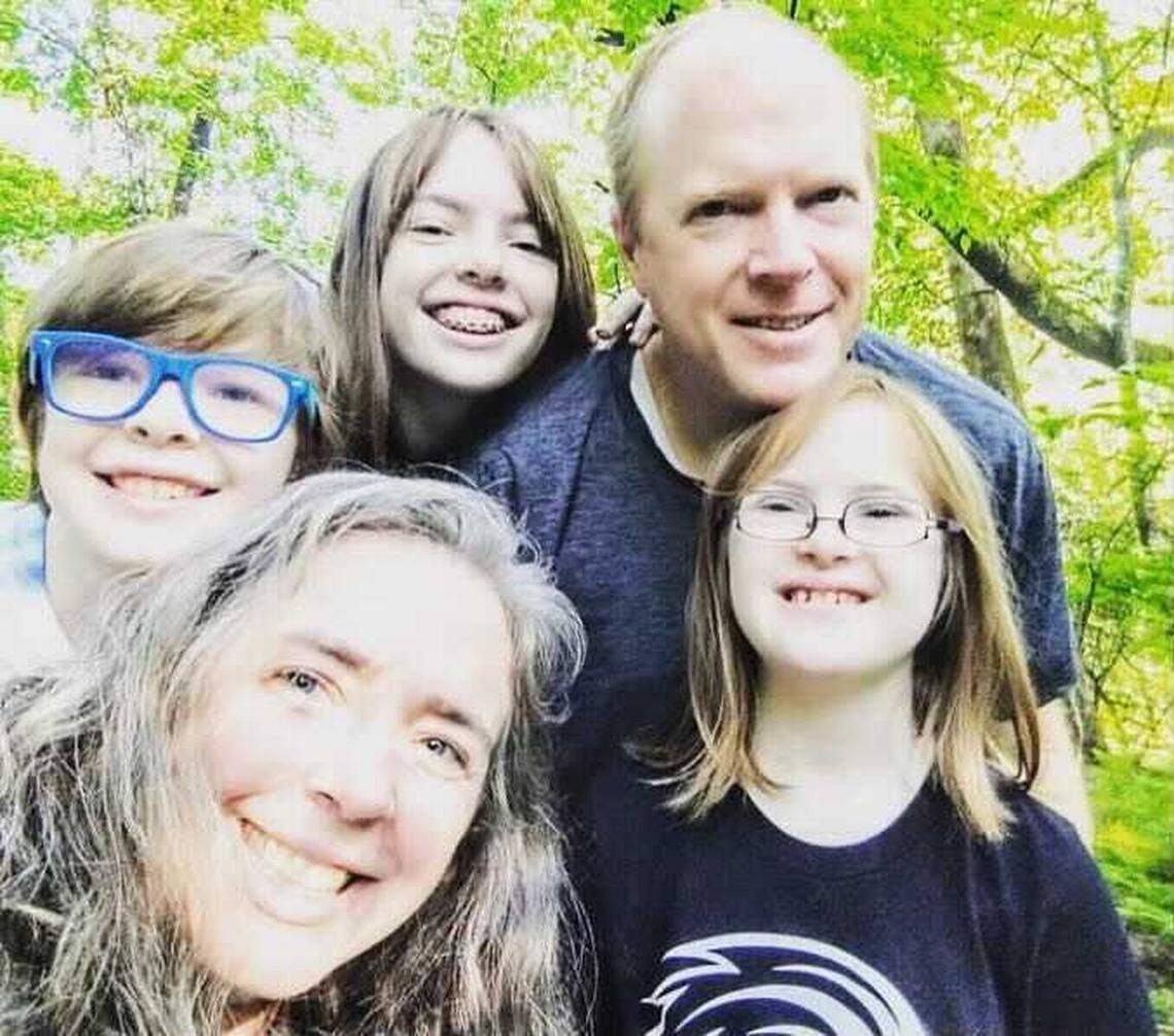 Nicole and Charlie Starkey, of Clemson, stop to take a family photo with their three children, Emma, 9, Maddie, 14, and Abbie, 12. Three of the five family members contracted COVID-19.