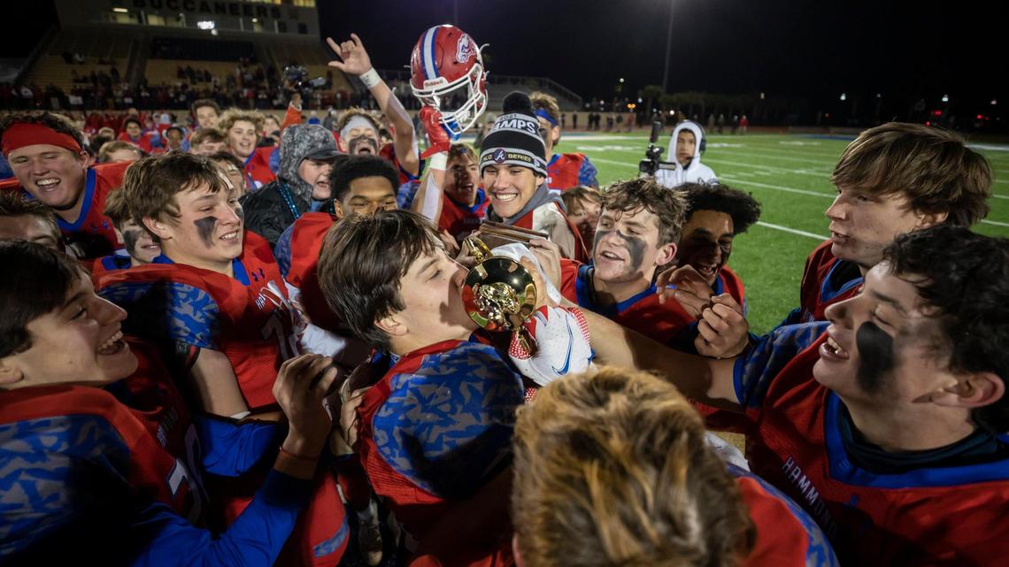 Hammond School players take turns kissing the trophy after defeating Trinity Collegiate School, 48-15, in the SCISA Class 3A State Championship Game held at Buccaneer Field at Charleston Southern University on Friday, November 19, 2021.