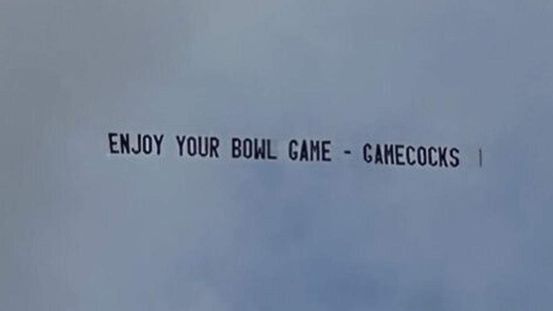 A banner reading “ENJOY YOUR BOWL GAME - GAMECOCKS” flies above Hard Rock Stadium in Miami Gardens, Florida, ahead of the 2022 Orange Bowl. South Carolina essentially eliminated both participants, Tennessee and rival Clemson, from College Football Playoff contention in consecutive weeks.