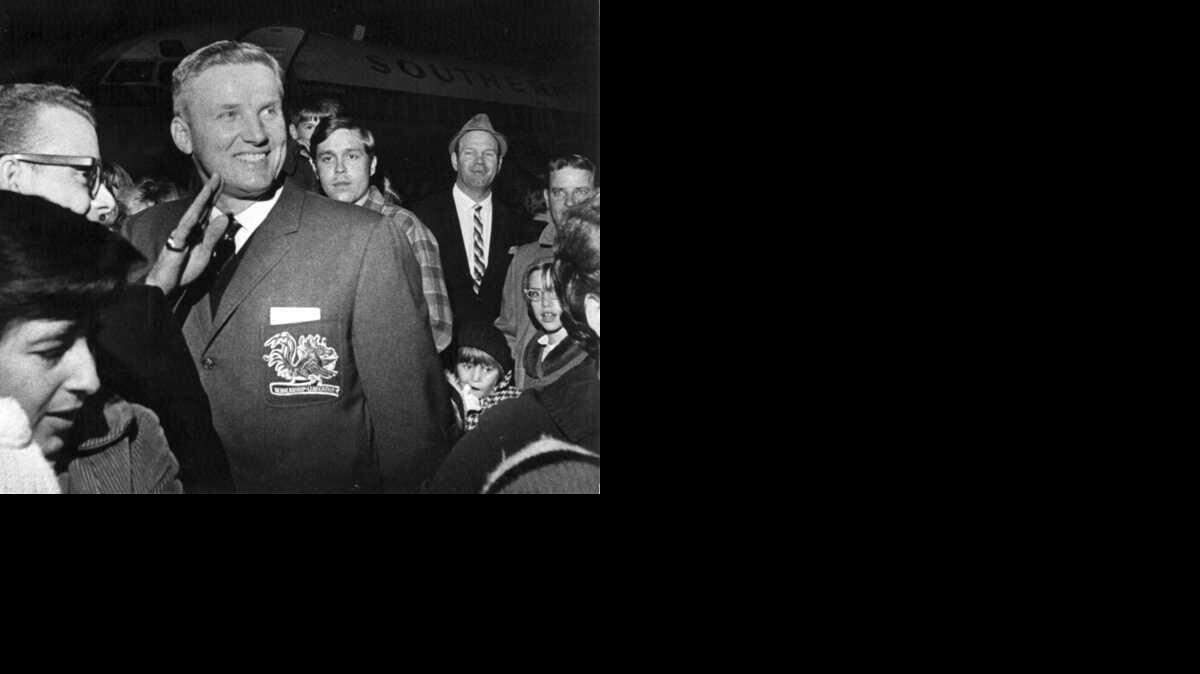 USC football coach Paul Dietzel waves to the crowd at the Columbia Metropolitan Airport upon arriving in Columbia after the Gamecock's victory over Wake Forest to give them their first ACC football championship in 1969.