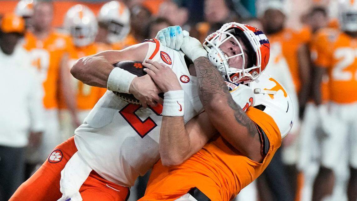 Clemson quarterback Cade Klubnik (2) is tackled by Tennessee defensive lineman Tyler Baron during the first half of the Orange Bowl NCAA college football game Friday, Dec. 30, 2022, in Miami Gardens, Fla. (AP Photo/Rebecca Blackwell)