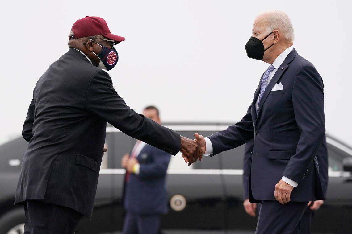 President Joe Biden is greeted by Rep. James Clyburn, D-S.C., as he arrives at Columbia Metropolitan Airport on Air Force One in West Columbia, S.C., en route to South Carolina State University in Orangeburg, S.C., Friday, Dec. 17, 2021. (AP Photo/Carolyn Kaster)