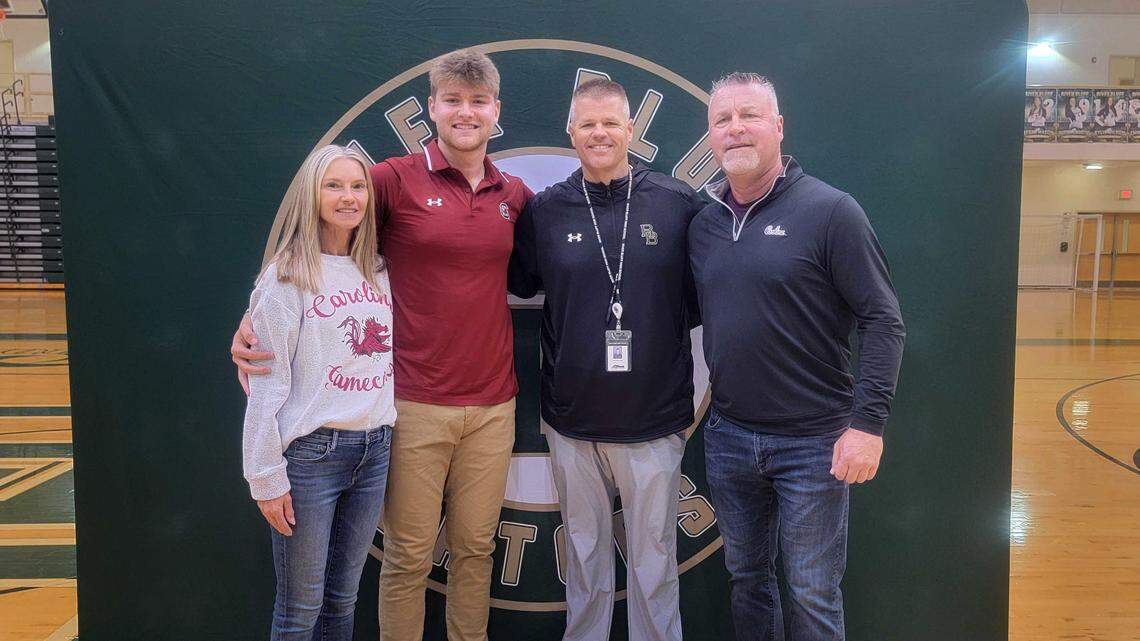 River Bluff’s Beau Hollins poses for a photo with mother Terri, coach Mark Bonnette and father Dave on Wednesday, Nov. 8, 2023. Hollins signed to play baseball at South Carolina.