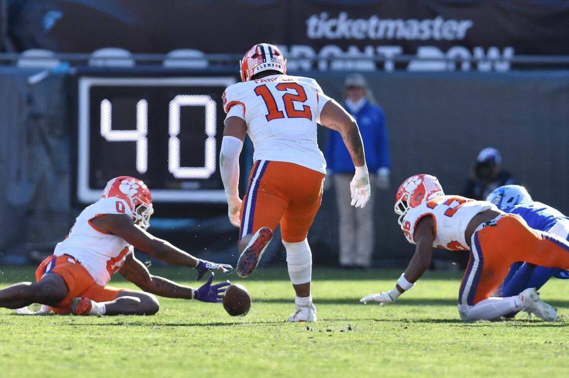 Clemson Tigers linebacker Barrett Carter (0) grabs a fumble from Kentucky Wildcats wide receiver Barion Brown (7) during fourth quarter action. The Kentucky Wildcats faced off against the Clemson Tigers Friday, December 29, 2023, in the TaxSlayer Gator Bowl in Jacksonville, Florida.