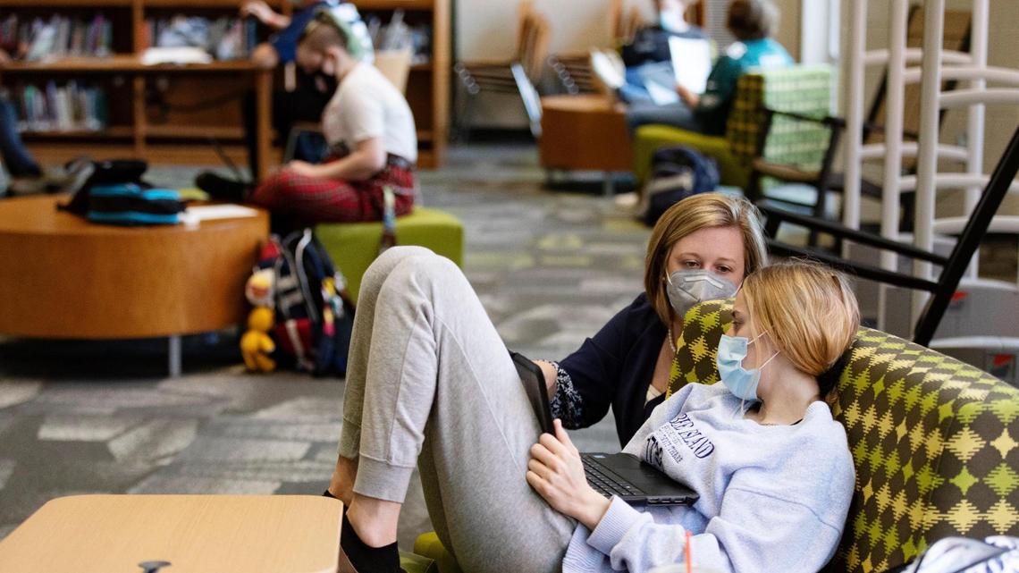 Kayla Hostetler talks to Addison Feraldi, a junior, during her English IV Honors class at Aiken High School on Tuesday, March 23, 2021. Feraldi is working on a project about student mental health during the coronavirus pandemic.