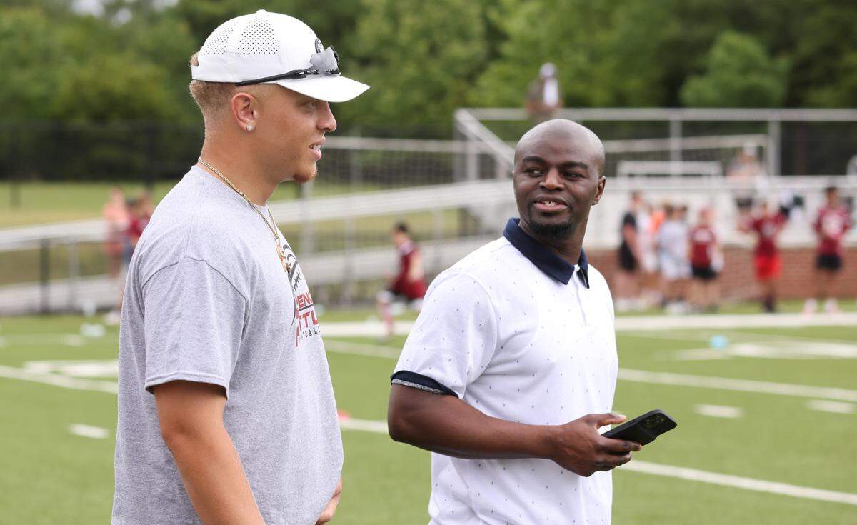 South Carolina quarterback Spencer Rattler speaks with Selwyn Roberts, vice president of branded content for Steinberg Sports, during the Spencer Rattler FlexWork Football Camp at Dreher High School in May.