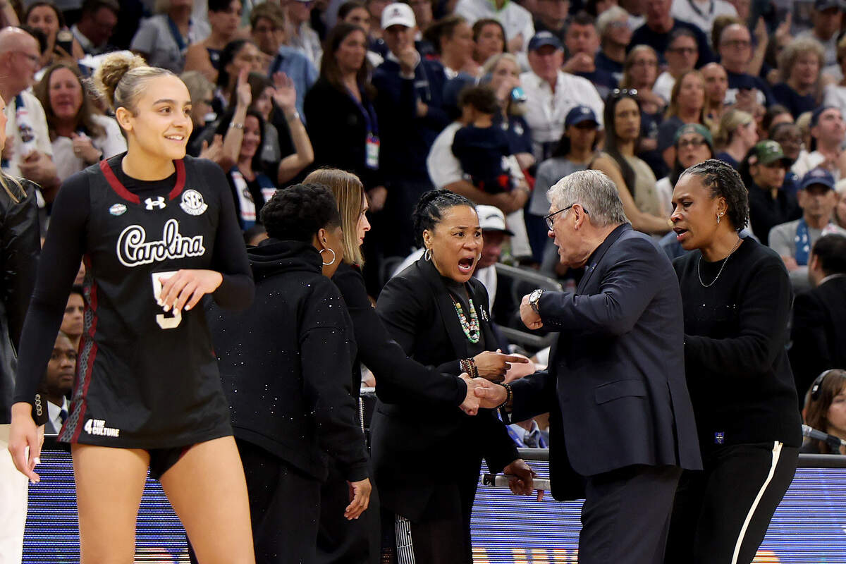 Head coach Dawn Staley of the South Carolina Gamecocks and head coach Geno Auriemma of the UConn Huskies exchange words April 3 during the final seconds of the fourth quarter in the Final Four of the NCAA Women's Basketball Tournament at Mortgage Matchup Center.
