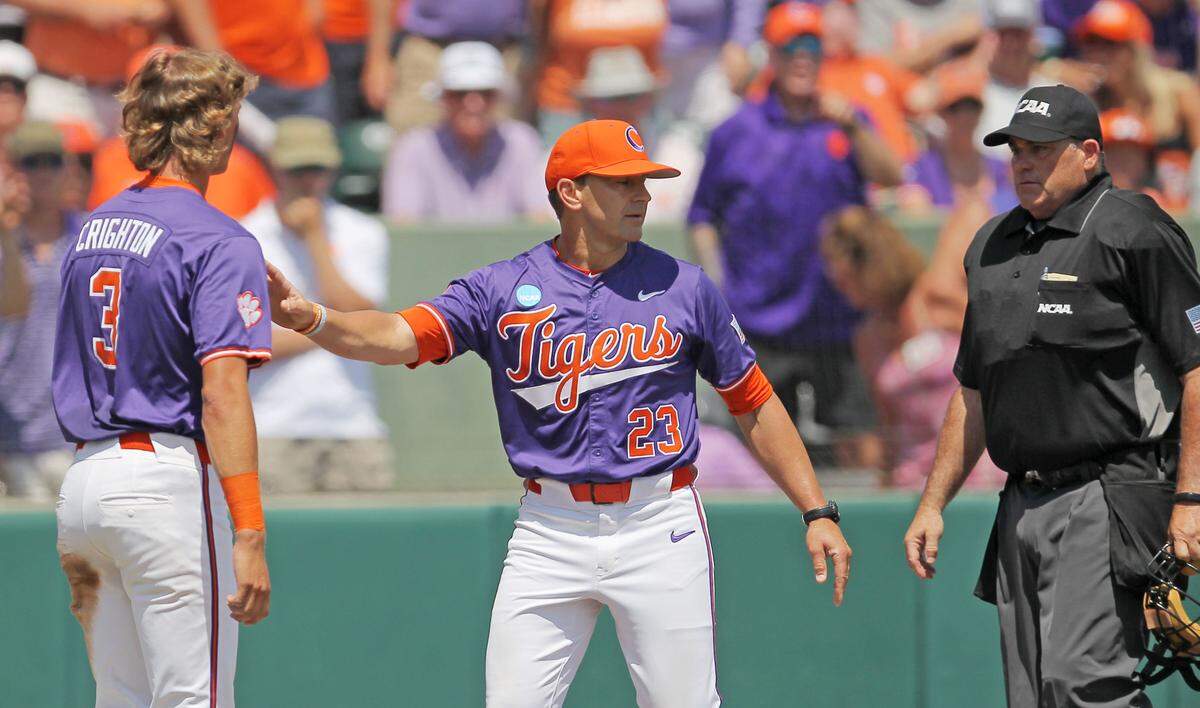 Clemson head coach Erik Bakich keeps Jack Crighton away from the umpire after an altercation during NCAA Super Regionals action on Sunday, June 9, 2024 in Clemson, S.C.