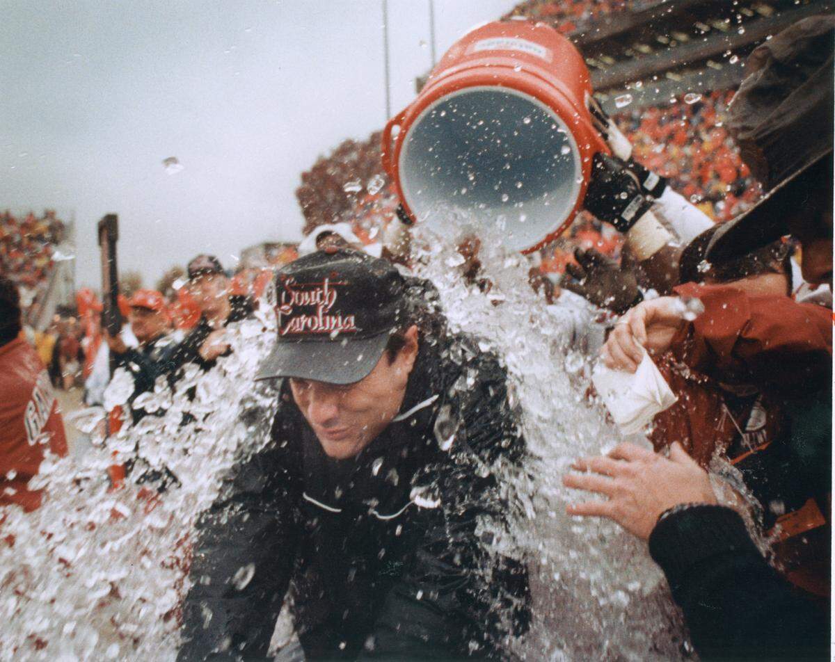 USC head coach Sparky Woods is showered with a bucked to ice water to celebrate the victory over Clemson on November, 21, 1992.