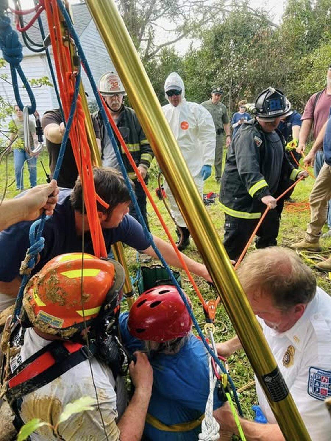 Rescuers worked to aid a woman who was trapped in a well.
