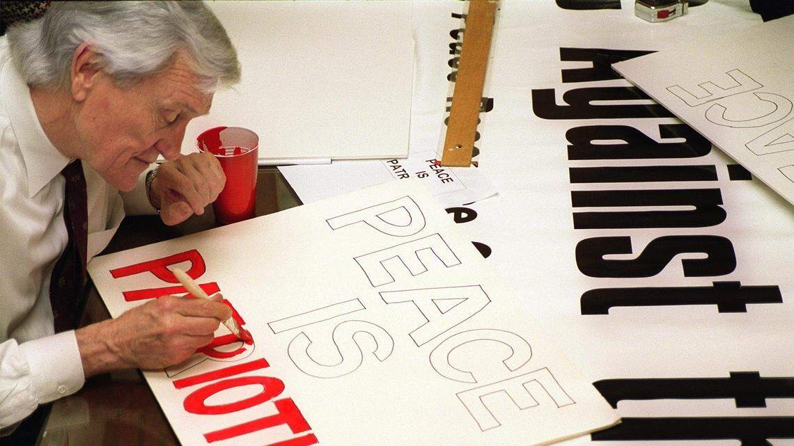 Carolina Peace Resource Center members Tom Turnipseed, Turnipseed and Associates Founder, works on a sign to take to Washington, D.C. for the war protest on Saturday . (C. Aluka Berry-01/16/03)