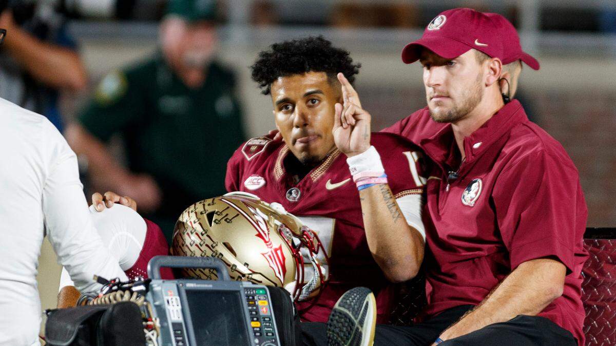 Nov 18, 2023; Tallahassee, Florida, USA; Florida State Seminoles quarterback Jordan Travis (13) waves to fans while being carted off after an injury against the North Alabama Lions during the first quarter at Doak S. Campbell Stadium. Mandatory Credit: Morgan Tencza-USA TODAY Sports