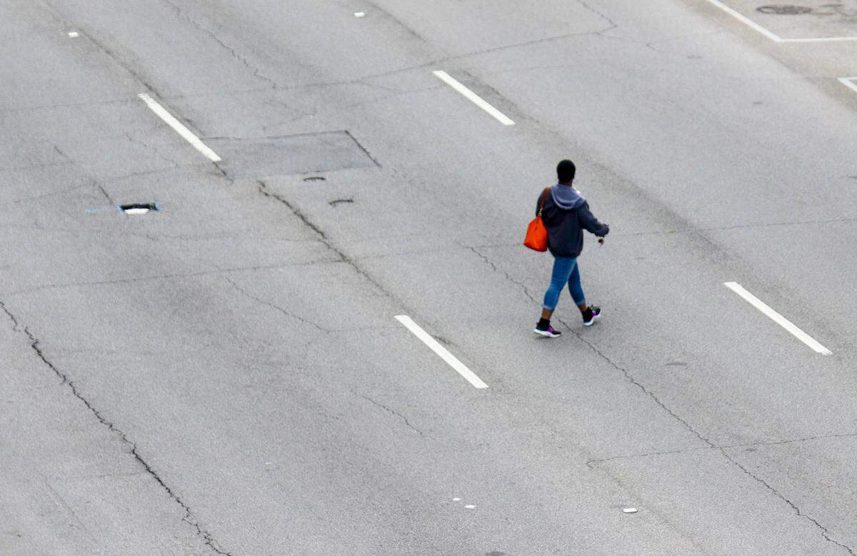 A person crosses Assembly Street in downtown Columbia.