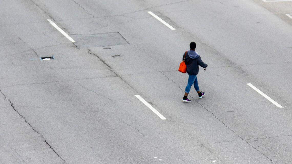 A person crosses Assembly Street in downtown Columbia.