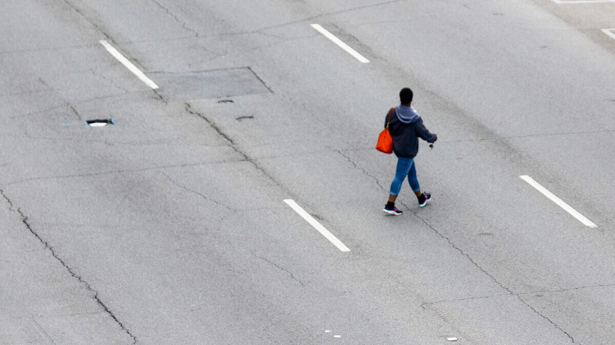 A person crosses Assembly Street in downtown Columbia.