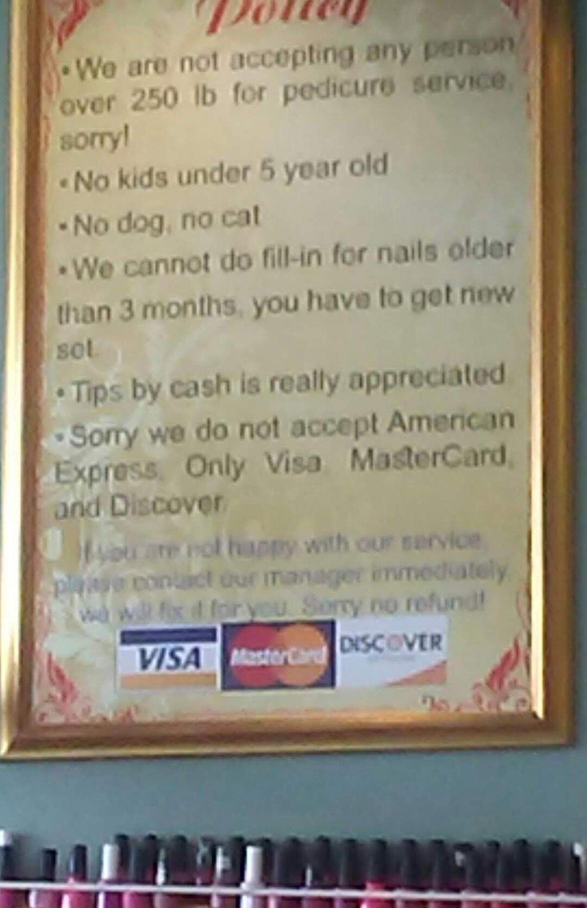 A sign in a Conway nail salon lists its policies, including a prohibition of pedicures for customers weighing more than 250 pounds.