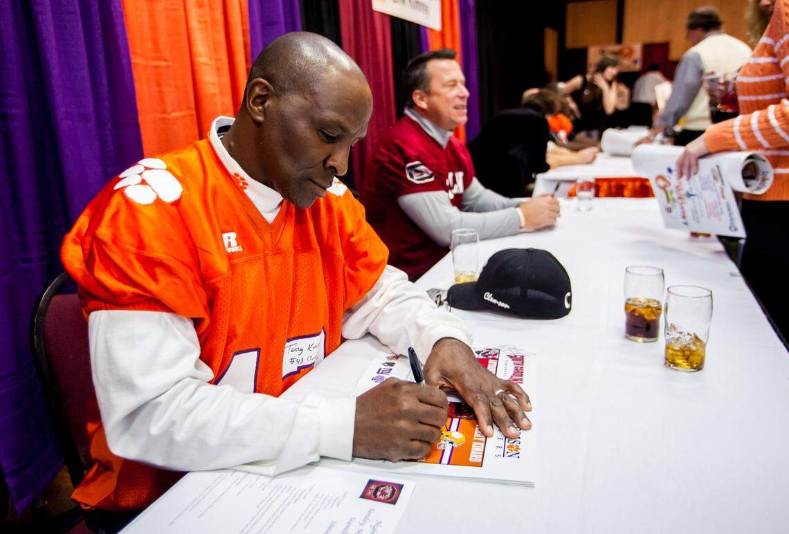 Clemson Tigers legend Terry Kinard signs an autograph during A Night with The Stars at Seawells, a Clemson/South Carolina fundraising event to benefit the Palmetto Health Richland Trauma Unit on Nov. 24, 2013.