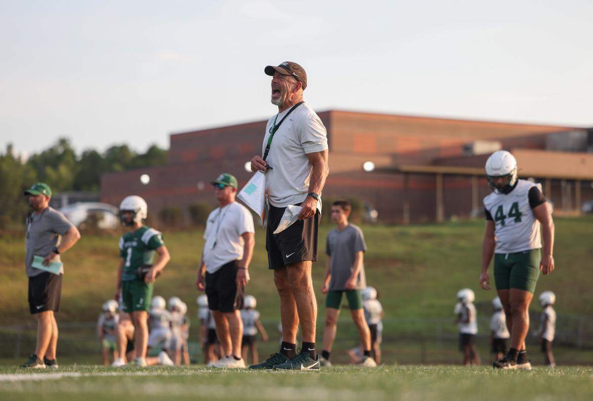 Dutch Fork head coach Tom Knotts shouts to his team during practice July 31.