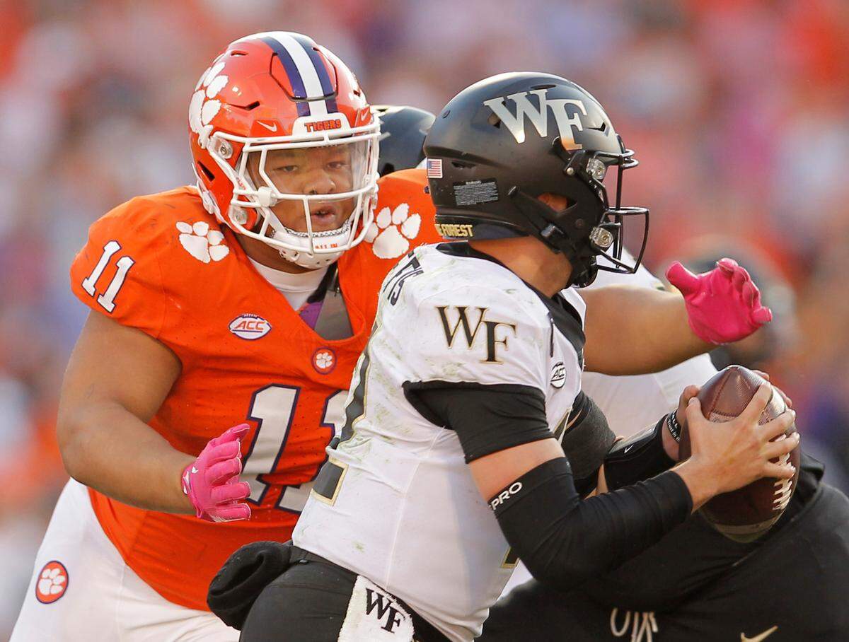 Clemson defensive tackle Peter Woods (11) gets after Wake Forest quarterback Mitch Griffis (12) during second-half action in Clemson, S.C. on Saturday, Oct. 7, 2023. (Travis Bell/SIDELINE CAROLINA)