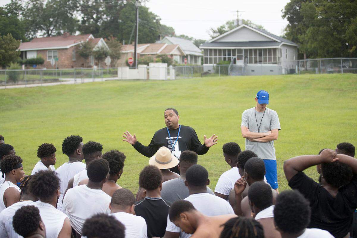 Allen University’s head football coach Ted Keaton speaks to his players after practice at Carver-Lyon Elementary School in Columbia, SC.