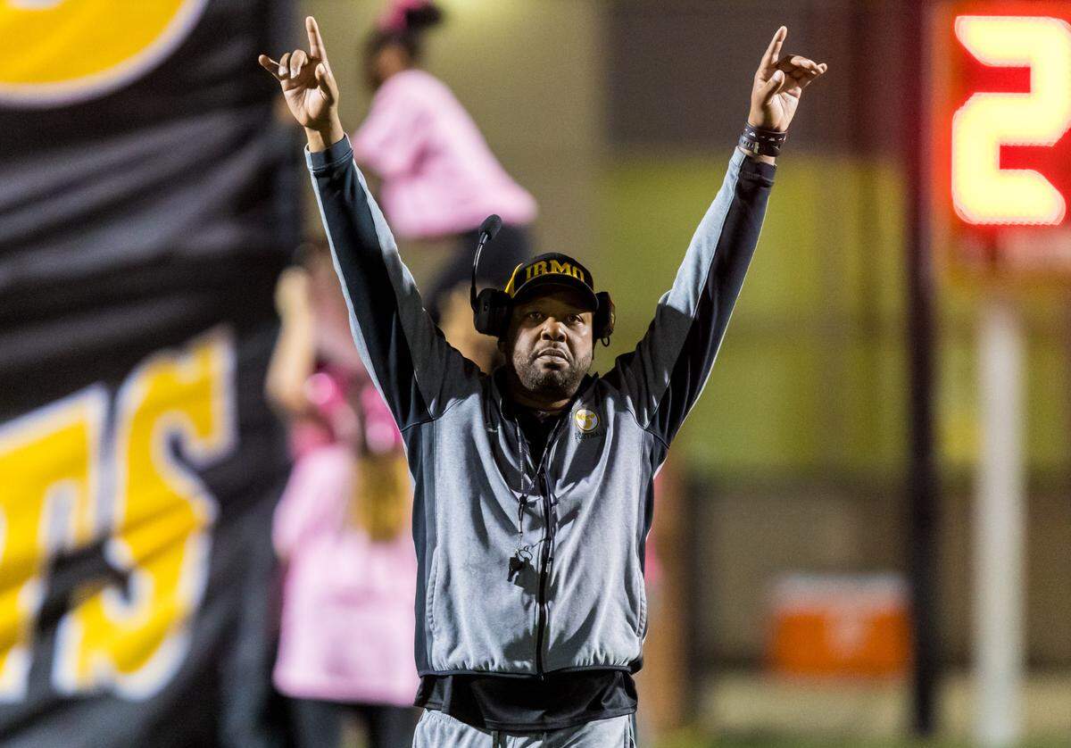 Irmo Yellow Jackets head coach Aaron Brand takes the field with his team before their Oct. 11 game against the River Bluff Gators.