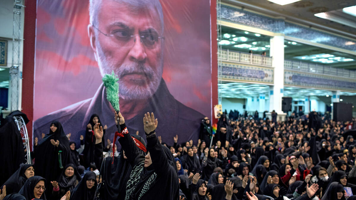 Iranians gather by a large portrait of Maj. Gen. Qasem Soleimani in Tehran, Iran, on Jan. 5, 2020, in public mourning of the country’s military leader who was targeted and killed by the U.S. in Baghdad. Huge crowds of mourners poured into the streets of two Iranian cities as his body was returned to Iran on Sunday. (Arash Khamooshi/The New York Times)