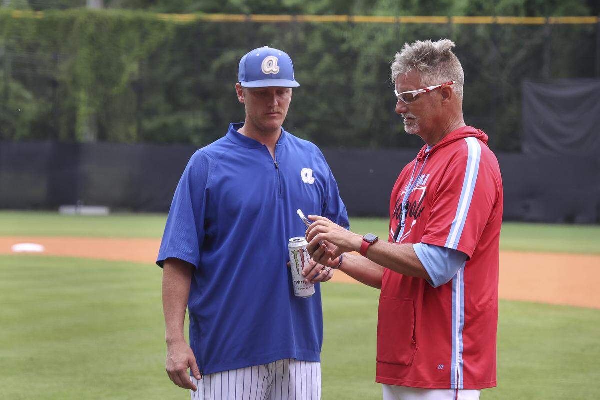 Airport head coach Casey Bradwell and AC Flora head coach Andy Hallett monitor the weather during a lightning delay before the first game of the class 4A state championships on Wednesday, May 27, 2026 at AC Flora high school.