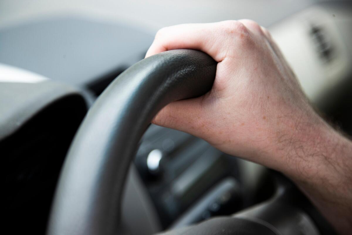 Tommy Broadway, a food delivery driver in Camden, South Carolina, holds the steering wheel of his car on Wednesday, March 18, 2020. One of his concerns possibly coming in contact with the coronavirus while out on delivery, and then touching his steering wheel before washing his hands.