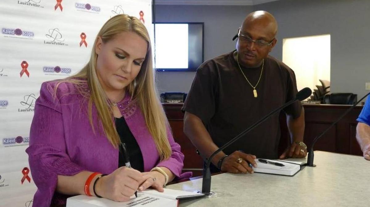 
Forensic criminologist Laura Pettler signs a copy of her book, ‘Crime Scene Staging Dynamics in Homicide Cases,’ for Pageland Police Sgt. James Whitaker, who was one of about 30 lawmen to attend Pettler’s workshop Tuesday in Lancaster on cold cases. 
