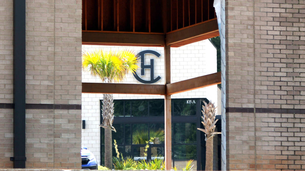 The Chophouse of Chapin sits across from the final unfinished building at the Chapin Commons shopping center, which has struggled to find tenants. June 1, 2024