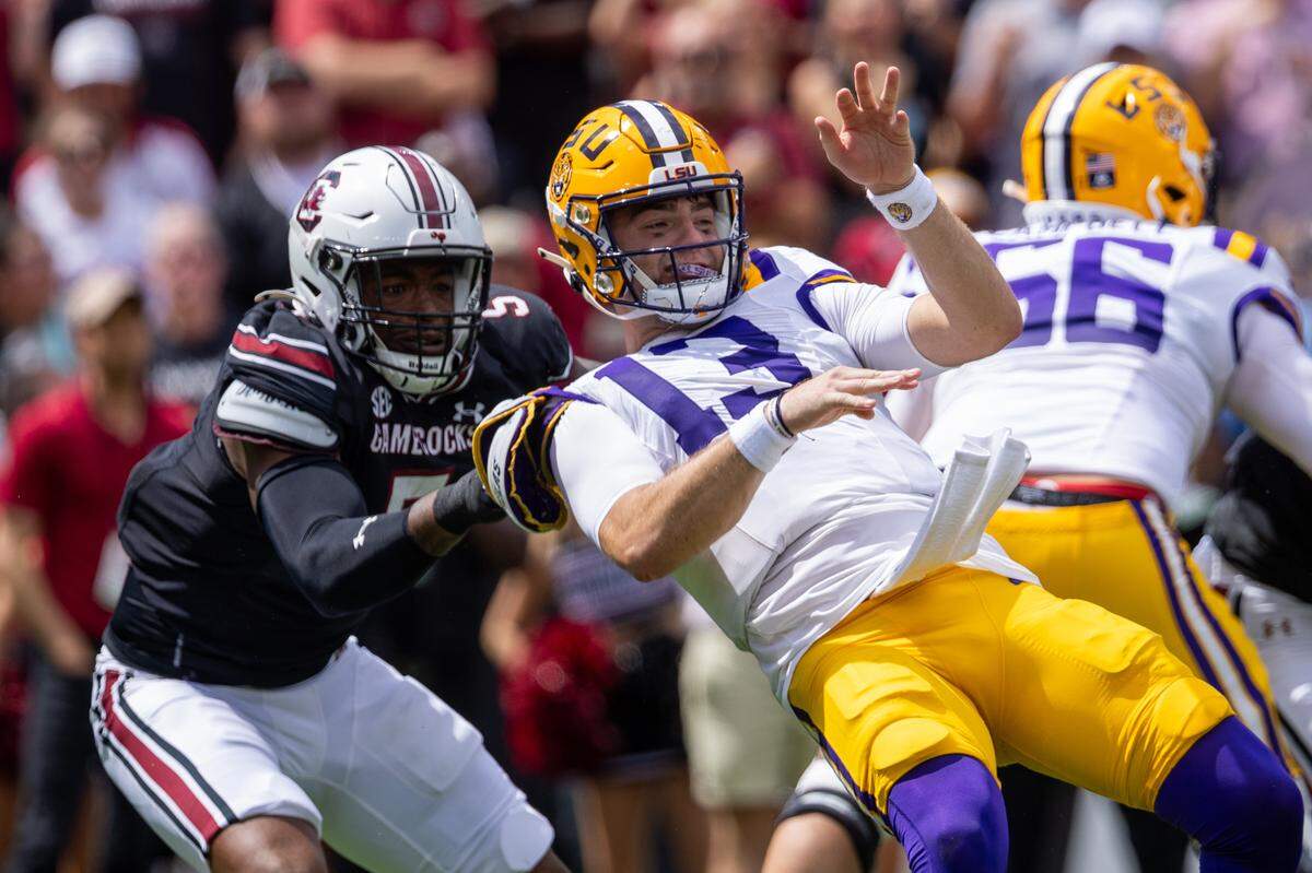 South Carolina Gamecocks edge Kyle Kennard (5) pulls down LSU Tigers quarterback Garrett Nussmeier (13) during the first quarter at Williams-Brice Stadium.