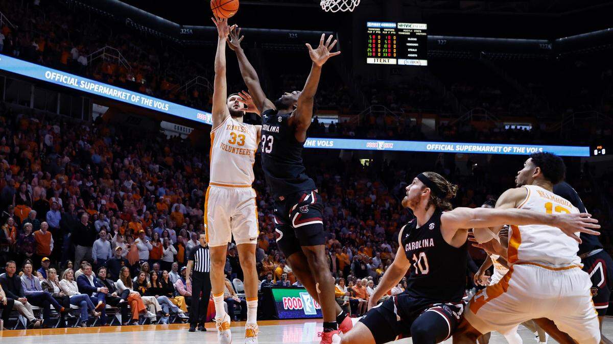 Tennessee forward Uros Plavsic, left, shoots over South Carolina forward Josh Gray during the first half of an NCAA college basketball game Saturday, Feb. 25, 2023, in Knoxville, Tenn. (AP Photo/Wade Payne)