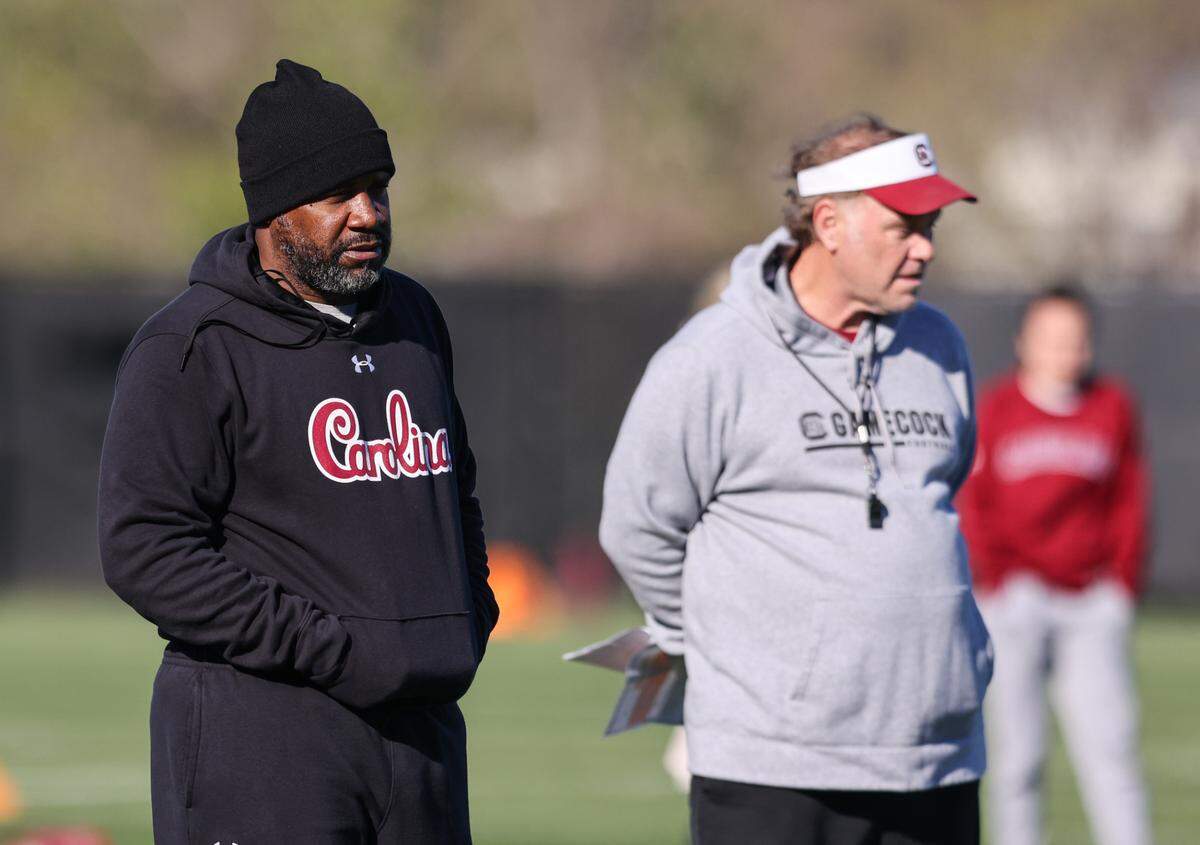 South Carolina running backs coach Marquel Blackwell and assistant coach Joe DeCamillis watch players during the Gamecocks’ practice in Columbia on Tuesday, March 19, 2024.