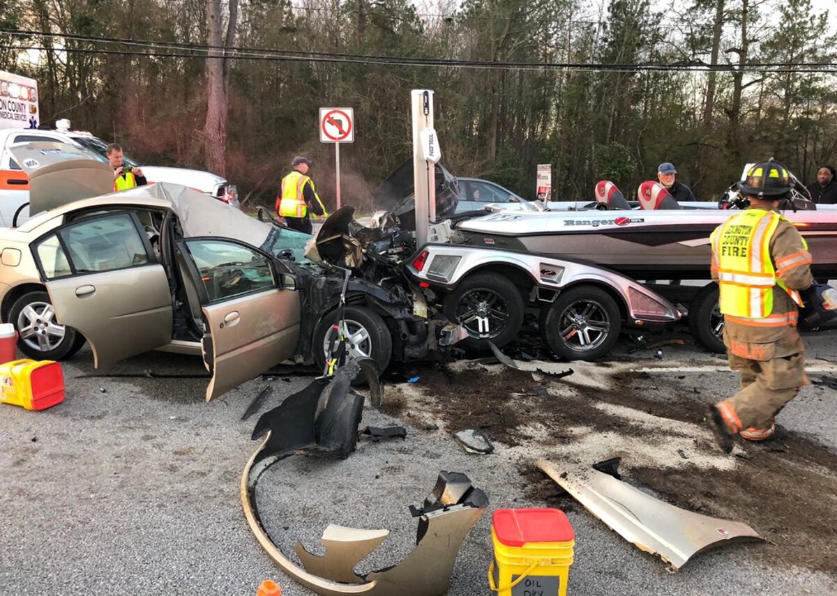 A collision between two vehicles, including a boat on a trailer, has a busy Lexington road blocked.