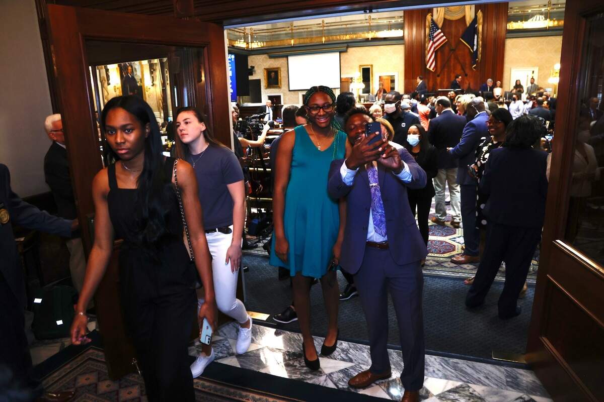 S.C. House Rep. Marvin Pendarvis, D-Charleston, right, takes a selfie with University of South Carolina women’s basketball player Aliyah Boston outside the S.C. House in Columbia, S.C., on Wednesday, April 6, 2022.