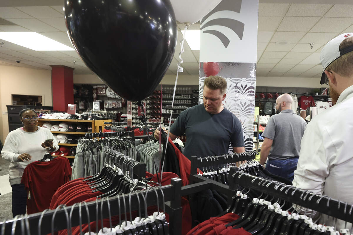 Zack Henderson, center, shops for Nike logo Gamecock apparel at the USC Campus Store at the Russell House on Wednesday, July 1, 2026.