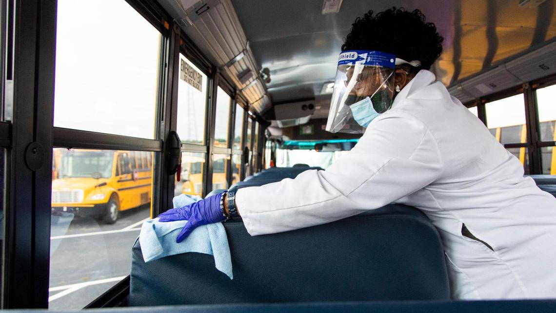 Toni Bates, a bus driver with the District 5 of Lexington and Richland Counties demonstrates new cleaning procedures at the school district’s bus depot on Thursday, August 6, 2020. In between trips high touch areas will be wiped down with disinfectant.
