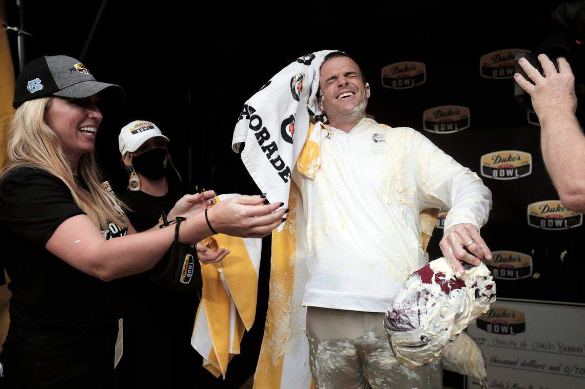 South Carolina Gamecocks head coach Shane Beamer whipes mayonnaise off himself after his team beat North Carolina at the Duke’s Mayo Bowl at Bank of America Stadium in Charlotte, North Carolina on Thursday, December 30, 2021.
