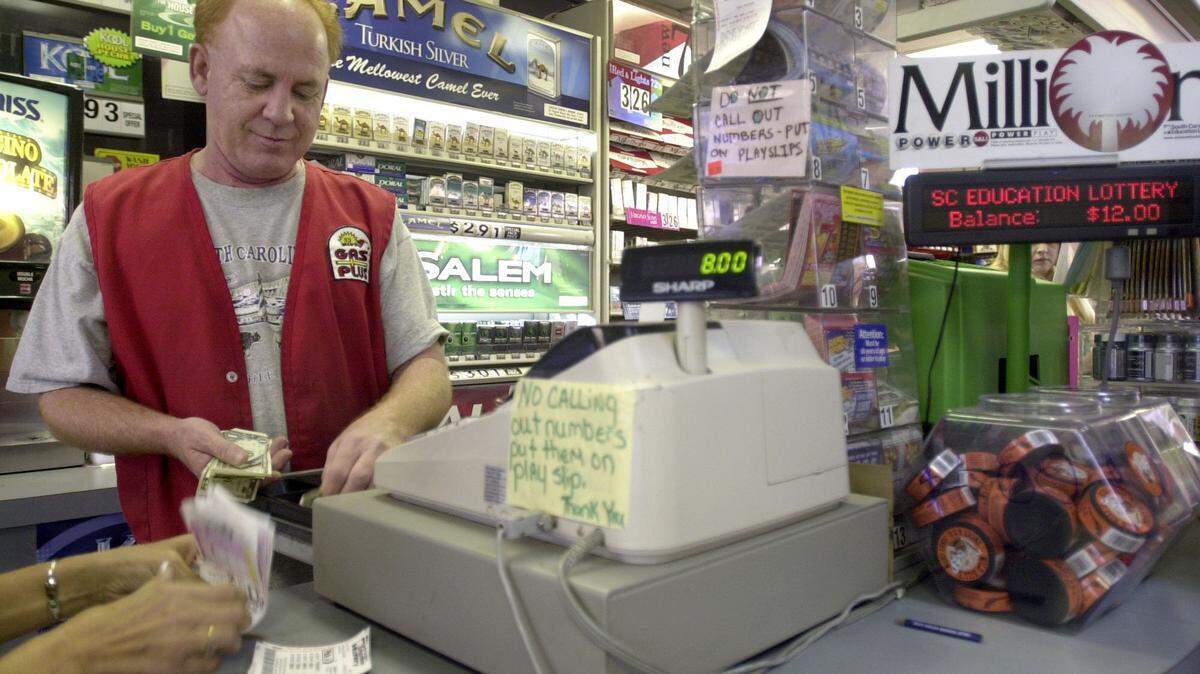 In this 2005 file photo, customers from both South Carolina and Georgia pour into Greg Gas Plus in North Augusta on Monday to buy lottery tickets. Gas station employee Jack Leverett Jr. makes change for a Lottery player, who plays everyday. This customer’s Monday picks were one number shy of a big win.