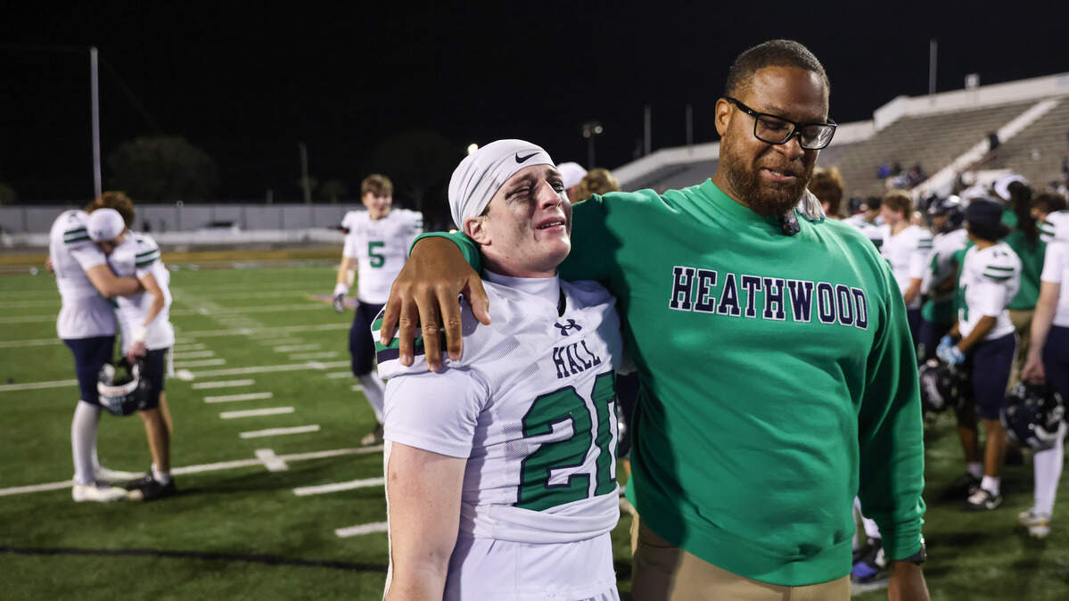 Julian Hughes (20) of Heathwood Hall is consoled by head coach Tymere Zimmerman following their team’s loss to Northwood Academy in the SCISA Class 4A Championship at Oliver C. Dawson Stadium in Orangeburg, SC, on Friday, November 21, 2025.


