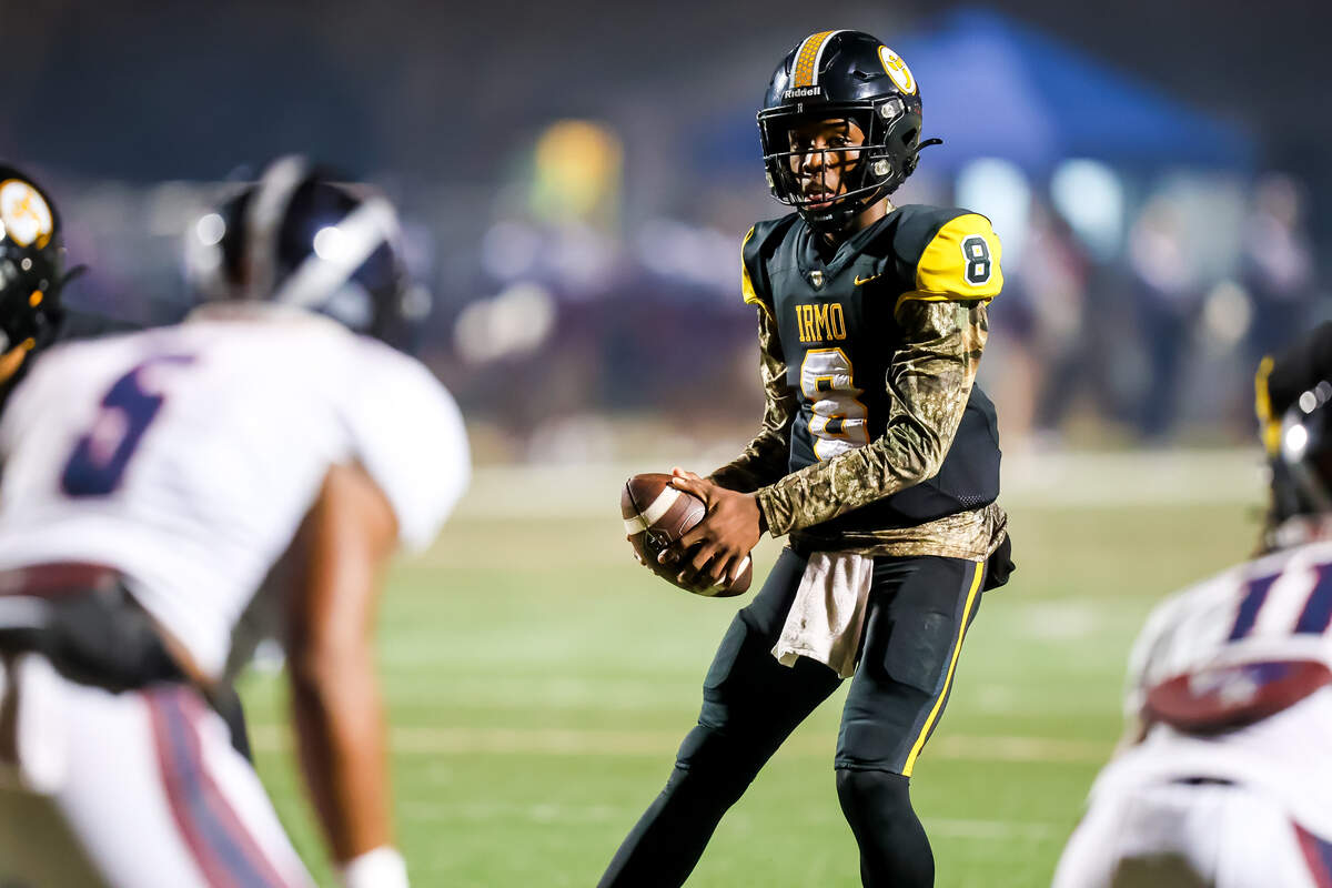 Irmo Yellowjackets quarterback Drevon Dopson (8) looks to pass against the White Knoll Timberwolves during their game at Irmo High School Friday evening, 11/21/25.