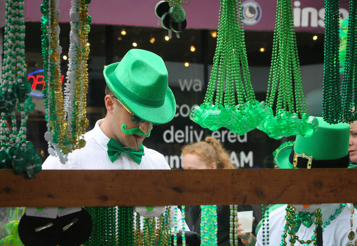 Ryan Bosler purchases beads from a pop-up stall at St. Pat’s in Five Points, March 17, 2018.