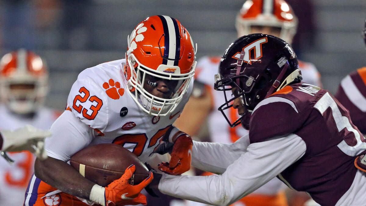 Clemson’s Lyn-J Dixon (23) gets past Virginia Tech’s Brion Murray for a touchdown in the second quarter of an NCAA college football game in Blacksburg, Va., Saturday, Dec. 5, 2020. (Matt Gentry/The Roanoke Times via AP, Pool)