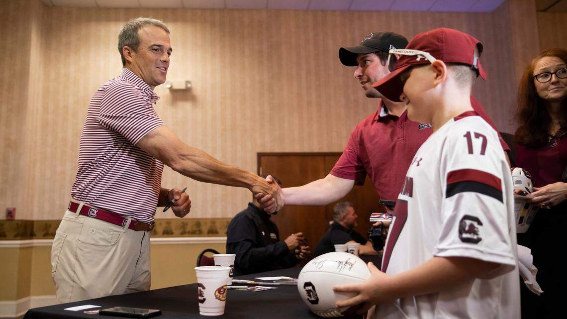 Football head coach Shane Beamer signs autographs for Justin Hill and Grayson Stroud, 10, during the Gamecock Welcome Home Banquet, organized by the Lexington and Richalnd County Gamecock Clubs, at Seawell’s in Columbia on Monday, May 8, 2023.