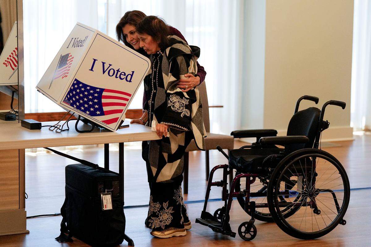 Republican presidential candidate former UN Ambassador Nikki Haley helps her mother Raj Kaur Randhawa vote Saturday, Feb. 24, 2024, in Kiawah Island, S.C. (AP Photo/Chris Carlson)