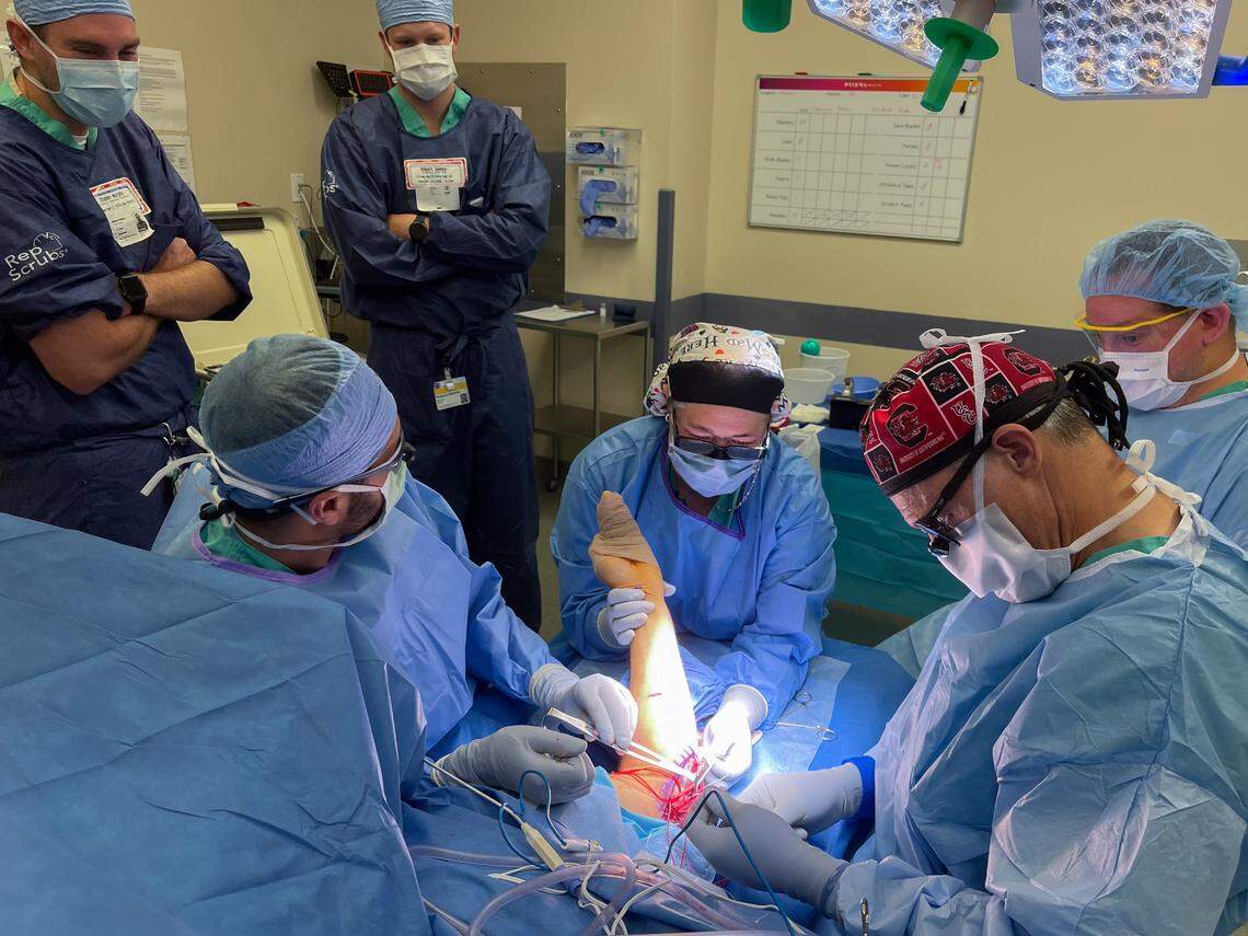 Dr. Christopher Mazoue, right, performs Tommy John surgery on Brandon Cromer on Thursday, June, 5, 2025 at Prisma Health Parkridge outpatient surgery.