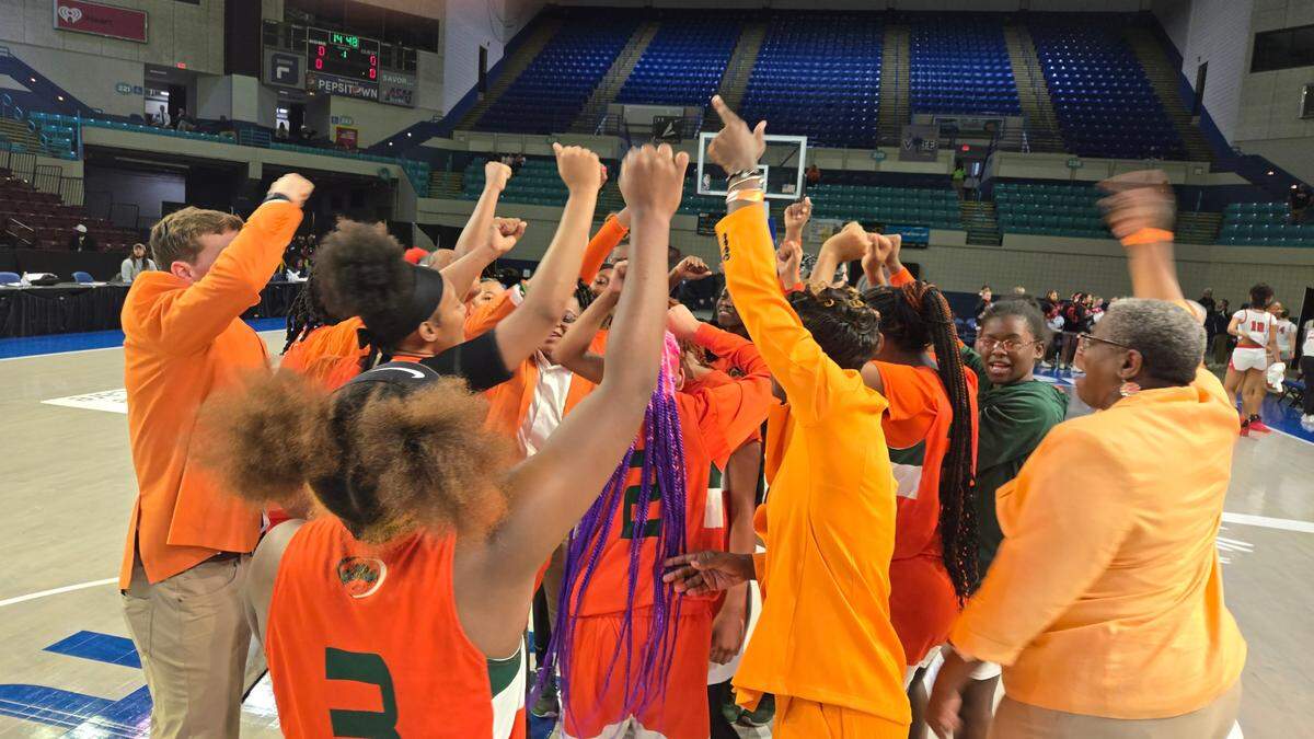 Eau Claire girls basketball players and coaches celebrate the team’s win over Clinton in the Class 2A Upper State championship game on March 4, 2025.